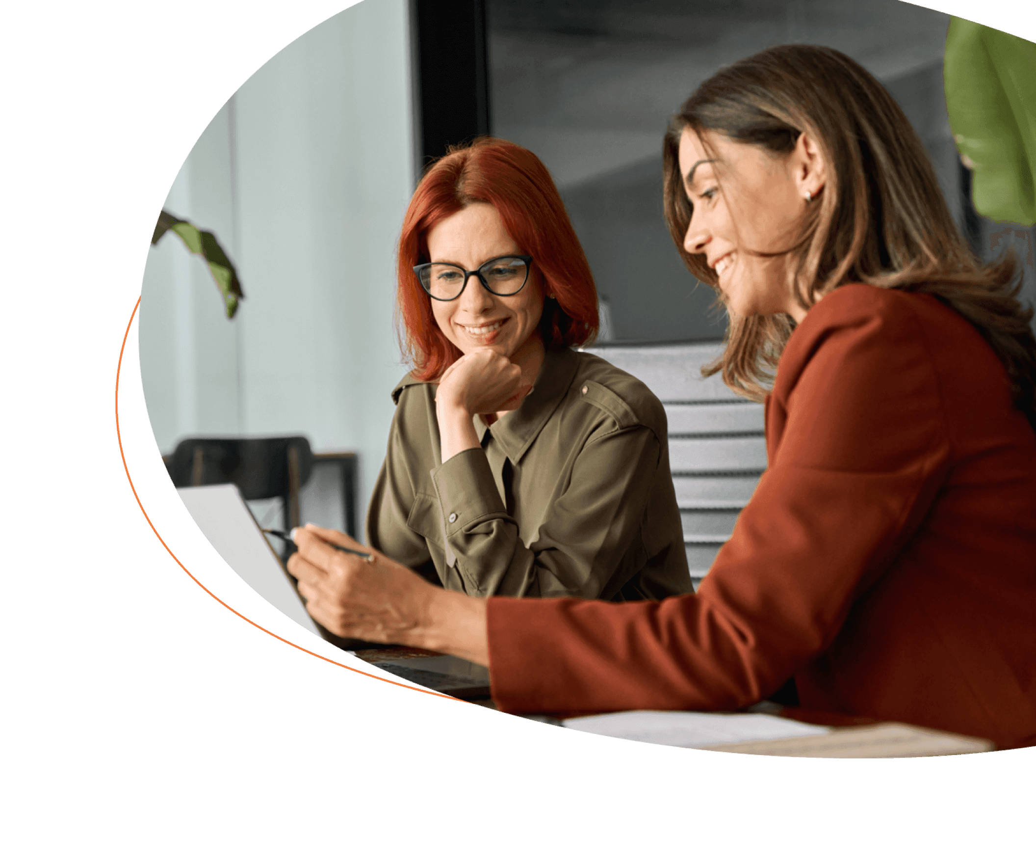 Two women collaborating at laptop