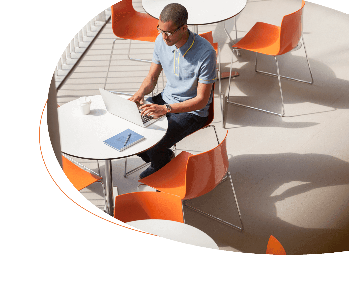 Overhead shot of man at desk on computer