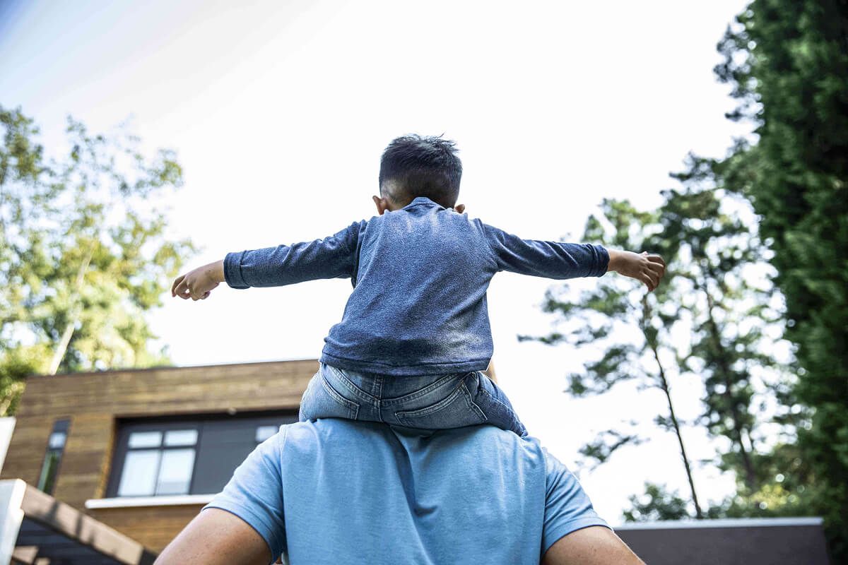 Boy on father’s shoulders.
