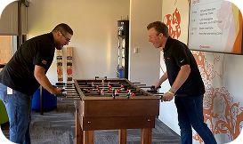 2 men playing foozball